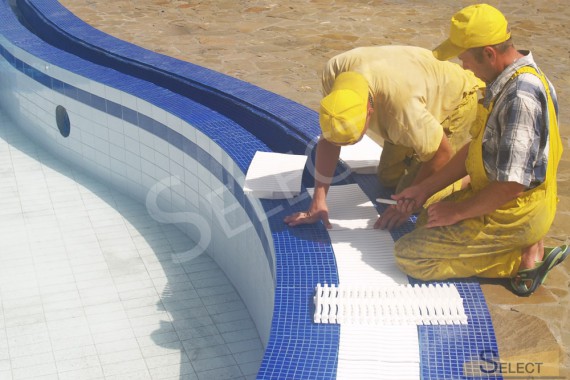 Photos of works on laying tiles for the pool and drain mechanisms
