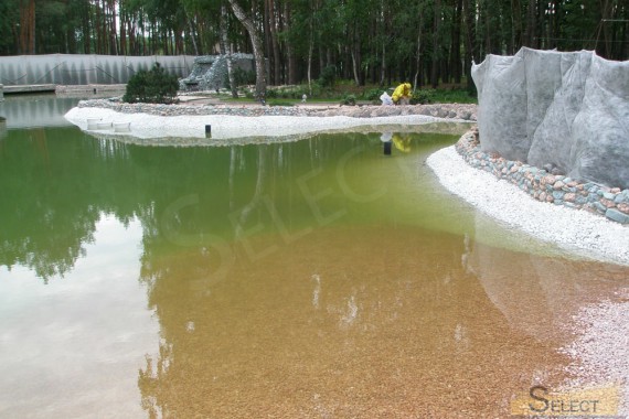 Filling an artificial pond in the backyard of the villa